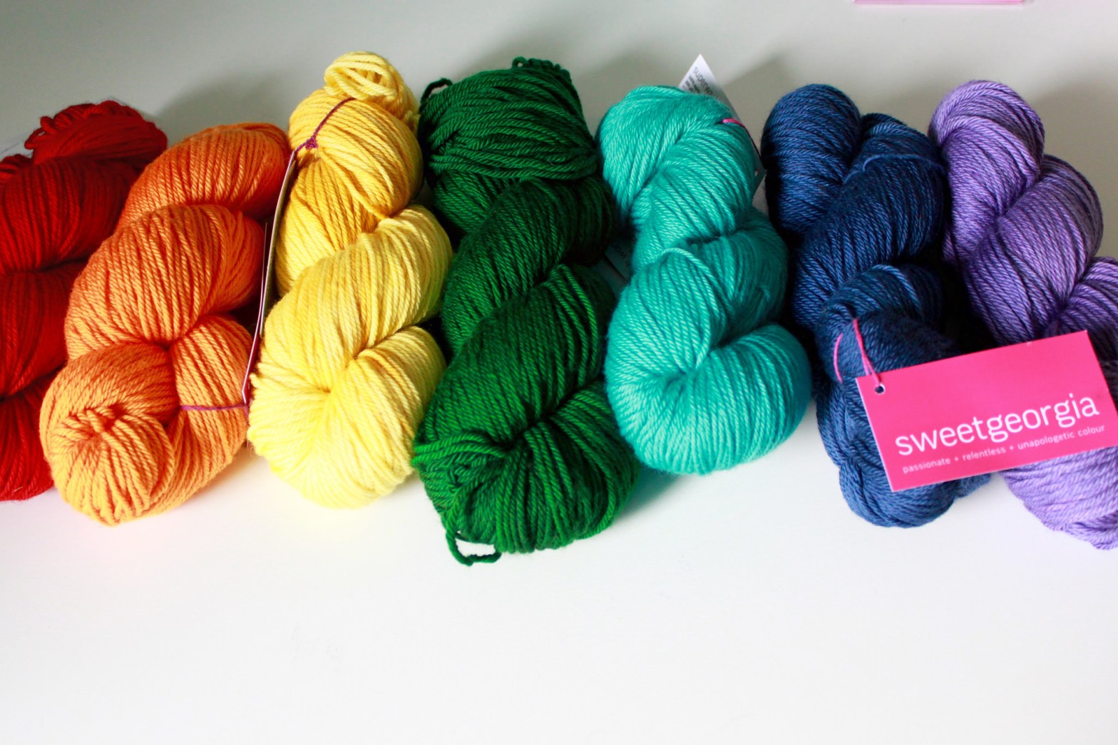 a rainbow of yarn on a table